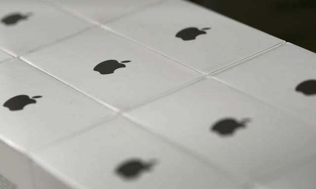 Apple logos are seen on boxes in a shop in Munich