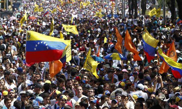 Opposition demonstrators take part in a protest against Venezuela's President Nicolas Maduro's government in Caracas