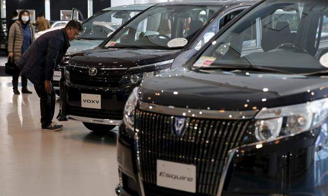 Man looks at Toyota Motor Corp's cars at the company's showroom in Tokyo