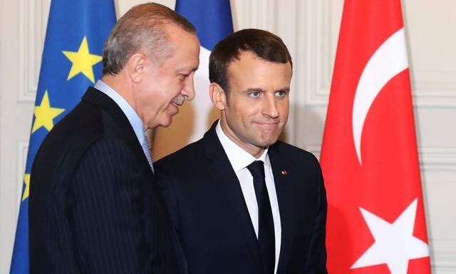 French President Emmanuel Macron and Turkish President Recep Tayyip Erdogan walk out  after a joint press conference at the Elysee Palace in Paris
