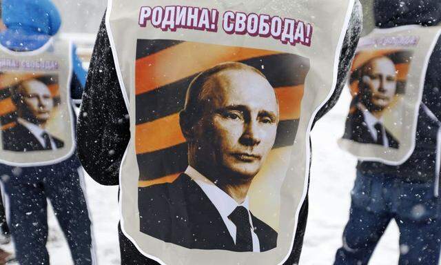 Participants wear vests depicting Russian President Putin during a support rally in Stavropol