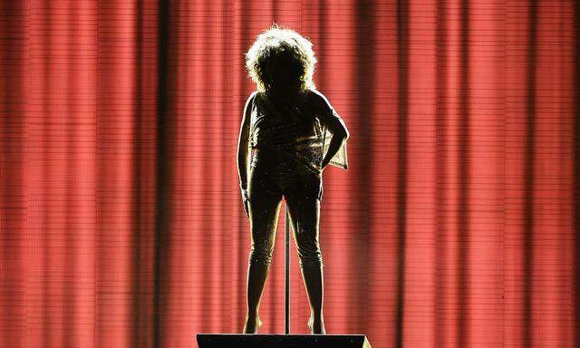 Tina Turner is silhouetted during her concert in London