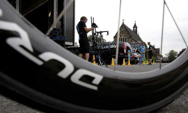 Sky Pro Cycling team staff members prepare bikes before a training session in Leeds