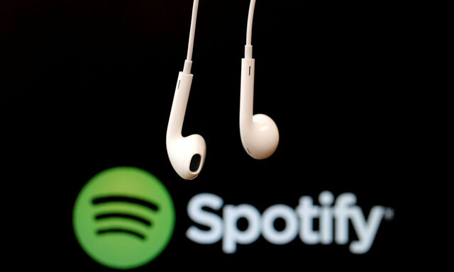 FILE PHOTO: Headphones are seen in front of a logo of online music streaming service Spotify in this illustration picture