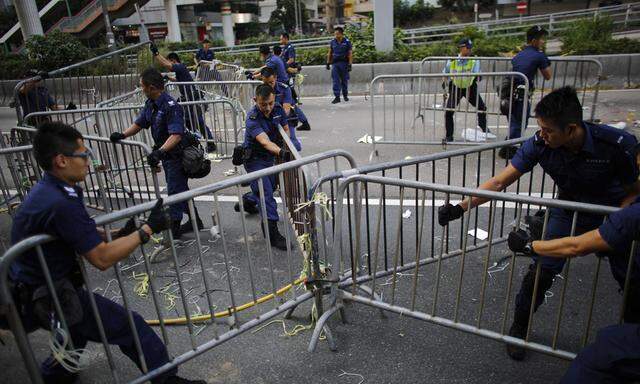 Police remove barricades at the main protest site in Admiralty in Hong Kong
