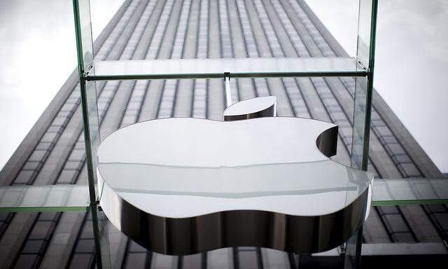 An Apple logo hangs above the entrance to the Apple store on 5th Avenue in the Manhattan borough of New York City