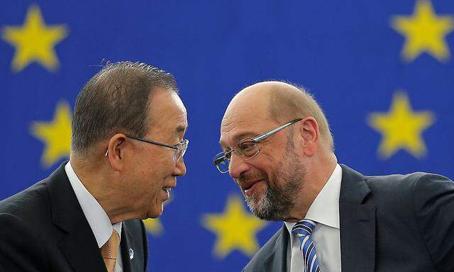 U.N. Secretary General Ban Ki-moon shakes hands with European Parliament President Schulz after the European Parliament vote in favor of the Paris UN COP21 Climate Change agreement in Strasbourg