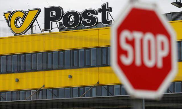 The logo of Austrian Post is pictured behind a traffic sign on the roof of Austrian Post logistics centre in Vienna