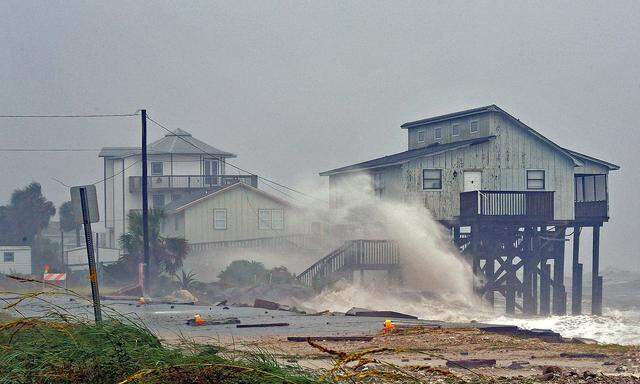 Waves crash on stilt houses along the shore due to Hurricane Michael at Alligator Point in Franklin County