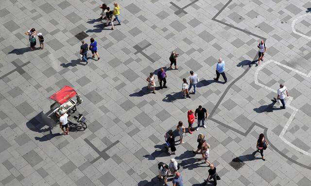 People walk over an outline of the historic Vergilius Chapel at St. Stephen's square in Vienna