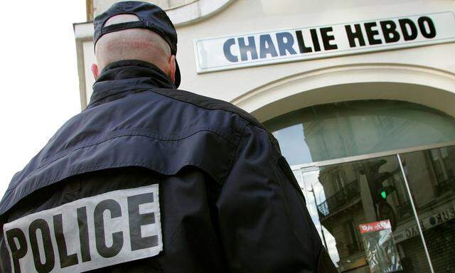 File photo of a policeman standing guard outside the French satirical weekly ´Charlie Hebdo´ in Paris