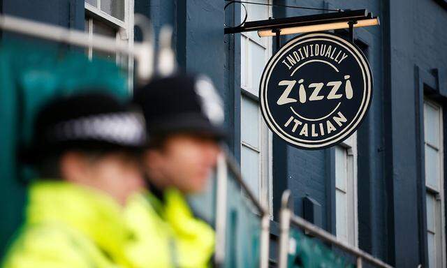 Police officers stand on duty outside a restaurant which has been secured as part of the investigation into the poisoning of former Russian inteligence agent Sergei Skripal and his daughter Yulia, in Salisbury
