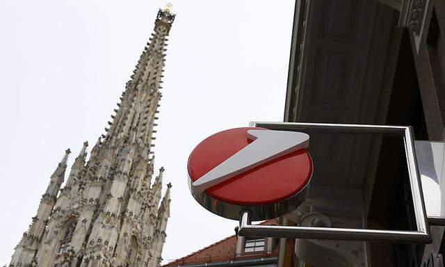 The logo of UniCredit, Italy's biggest bank by assets, is pictured next to a spire St. Stephen's cathedral at a UniCredit unit Bank Austria branch office in Vienna