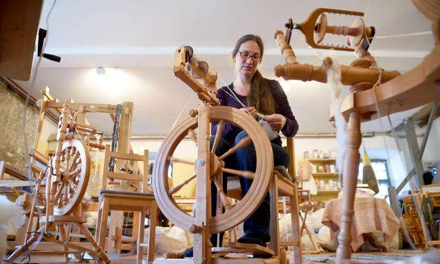 Christine Söllner an einem ihrer zahlreichen Spinnräder auf ihrem Hof in Niederösterreich.