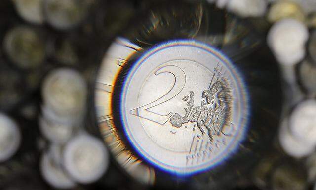 A two Euro coin is checked in the Austrian Mint headquarters in Vienna