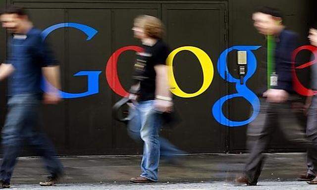 People walk past a logo next to the main entrance of the Google building in Zurich