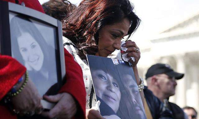 Grieving mother Cortinas holds a picture of her deceased son as she and fellow families of victims of the GM recall failure hold a news conference on the U.S. Capitol grounds in Washington