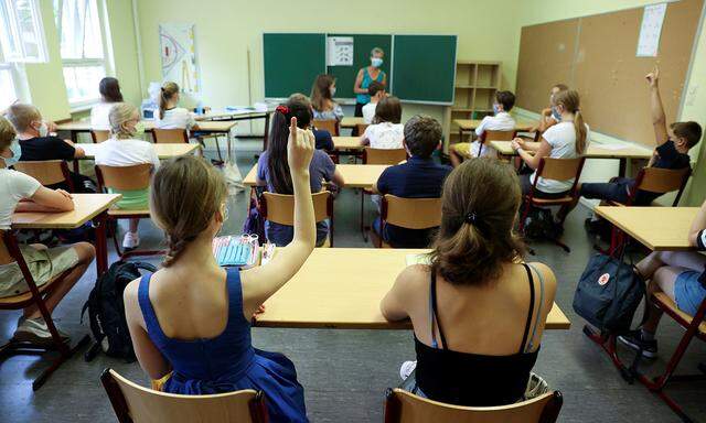 Pupils of the protestant high school ´Zum Grauen Kloster´ attend a lesson on the first day after the summer holidays in Berlin