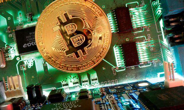 FILE PHOTO: Representation of the virtual currency Bitcoin is seen on a motherboard in this picture illustration