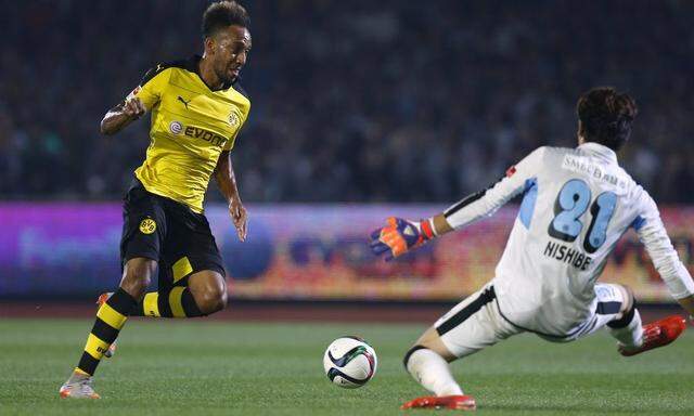 Borussia Dortmund's Aubameyang dribbles the ball against Kawasaki Frontale's Nishibe during their friendly soccer match as part of Borussia Dortmund's Asia Tour in Kawasaki