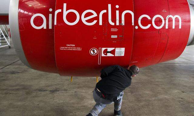 File photo of Air Berlin technician opening cover of jet engine of Air Berlin plane