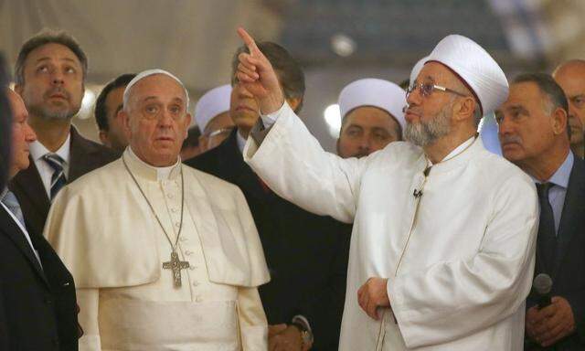 Pope Francis listens to Rahmi Yaran Mufti of Istanbul during visit to the Sultan Ahmet mosque, popularly known as the Blue Mosque, in Istanbul