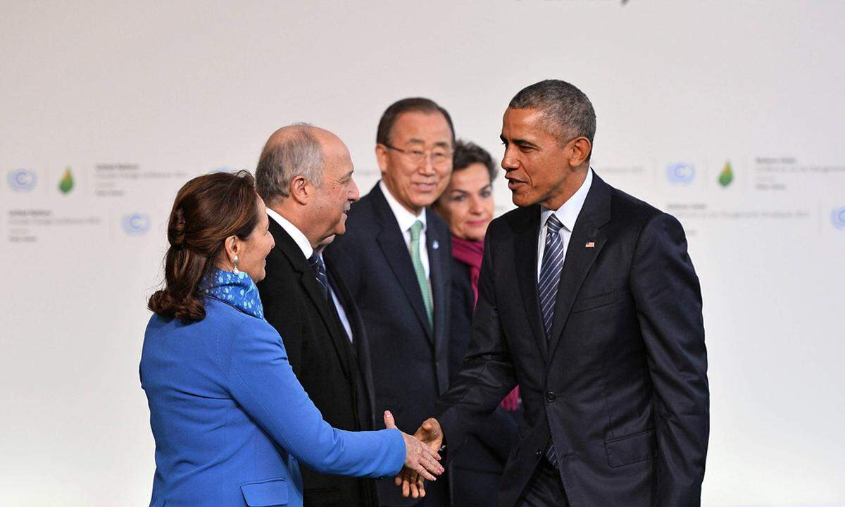 U S President Barack Obama R is greeted by from L to R French Environment Minister Segolene Roy