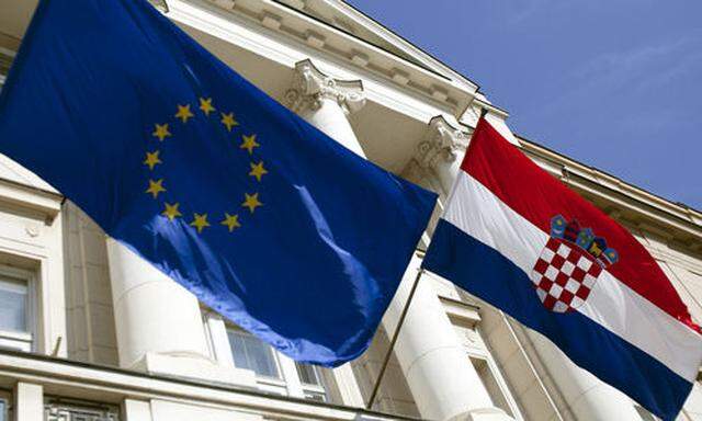 The Croatian and EU flags are seen at the parliament building at St. Mark square in Zagreb, Croatia, 