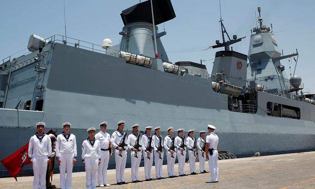 FILE PHOTO: German Navy armed personnel stand in front of the Frigate Hamburg, docked at Port Rashid, in Dubai