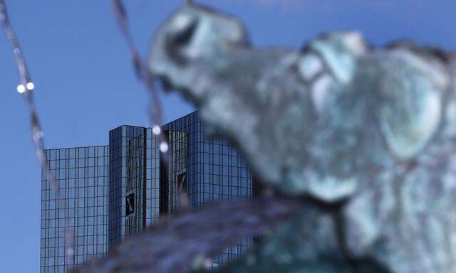 A sculpture of a dragon, part of a fountain, is seen next to the headquarters of Germany's Deutsche Bank in Frankfur