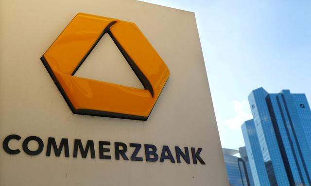 FILE PHOTO: FILE PHOTO: A sign for an ATM of Commerzbank is seen next to the headquarters of Deutsche Bank (R) in Frankfurt