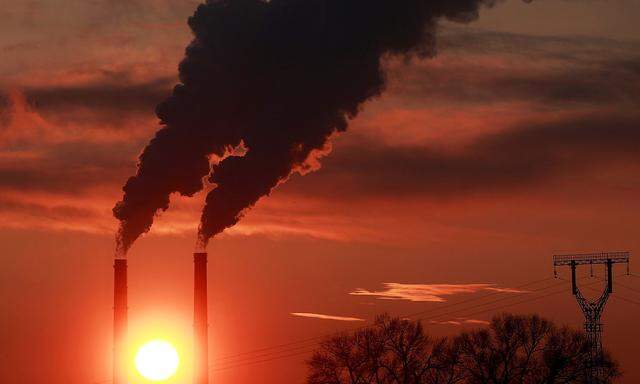 FILE PHOTO: The sun sets behind chimneys of a thermal power plant in Kyiv