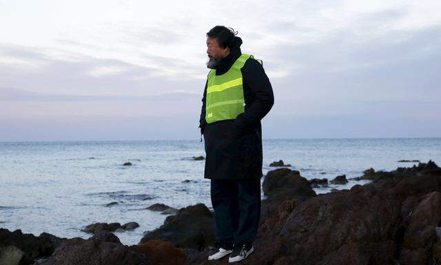 Chinese artist Ai Weiwei stands at a beach where refugees and migrants arrive daily on the Greek island of Lesbos