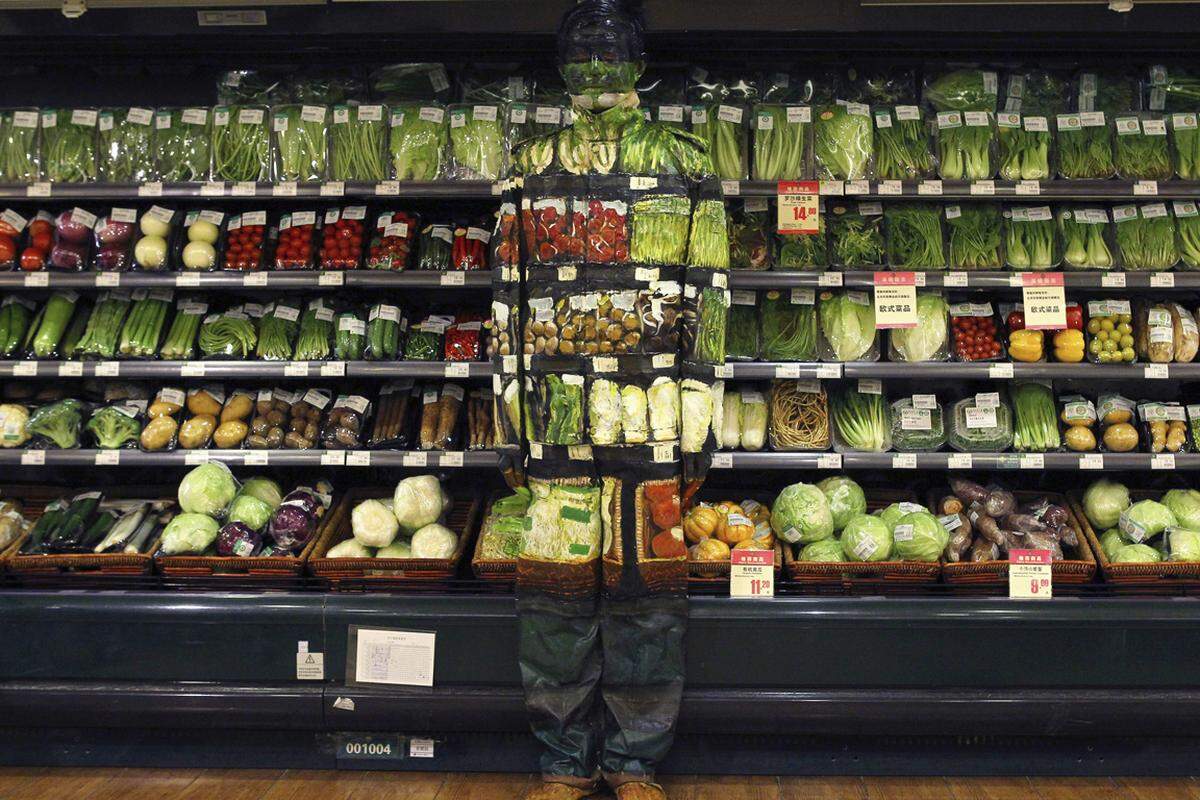 Künstler als Supermarkt-Chamäleon. Der chinesische Künstler Liu Bolin "verschwindet" vor dem Gemüseregal eines Pekinger Lebensmittelgeschäfts.