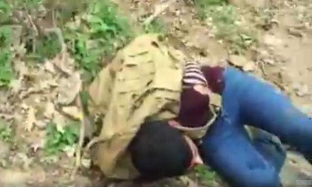 Ein Flüchtling liegt gefesselt auf dem Boden.