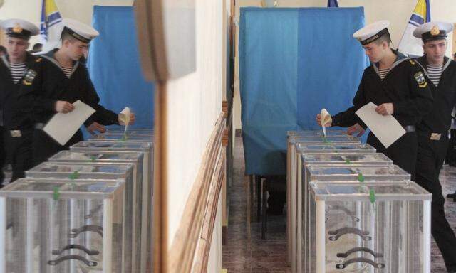 Ukrainian navy servicemen visit a polling station during the parliamentary elections in the Black Sea port of Sevastopol