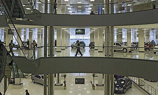 Visitors stroll through one of Europes largest auto dealerships, with room for 400 cars, which openes largest auto dealerships, with room for 400 cars, which opene