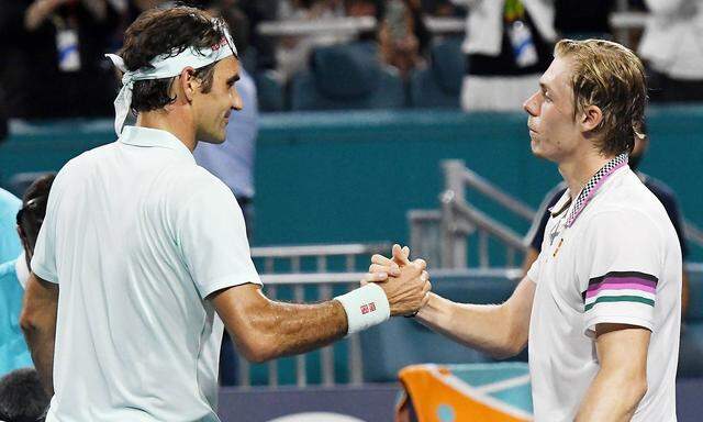 Roger Federer from Switzerland shakes hands with Denis Shapovalov from Canada after winning in two