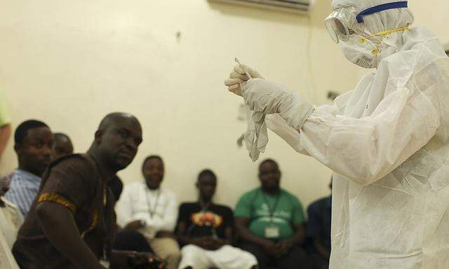 A Samaritan's Purse medical personnel demonstrates personal protective equipment to educate team members on the Ebola virus in Liberia in this undated handout photo