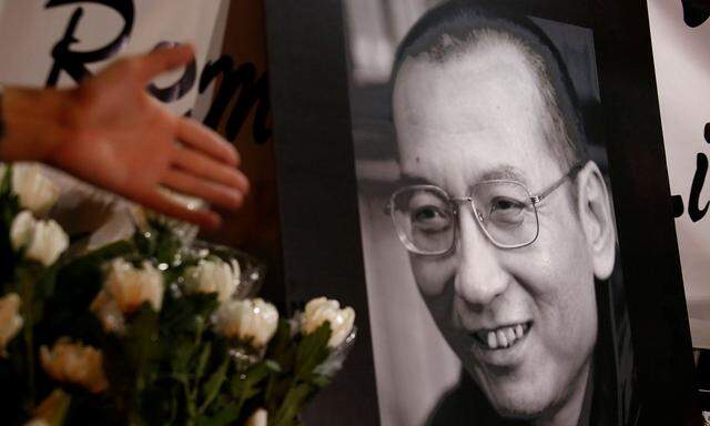 Flowers are laid beside a photo of the late Nobel Laureate Liu Xiaobo in Hong Kong