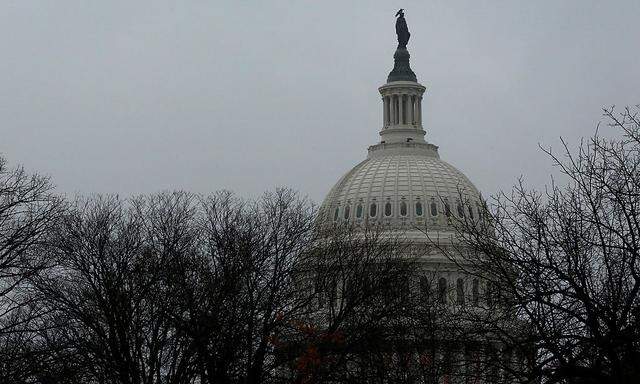 A rainy, gray sky tops the U.S. Capitol dome on the first day of the new session of Congress in Washington