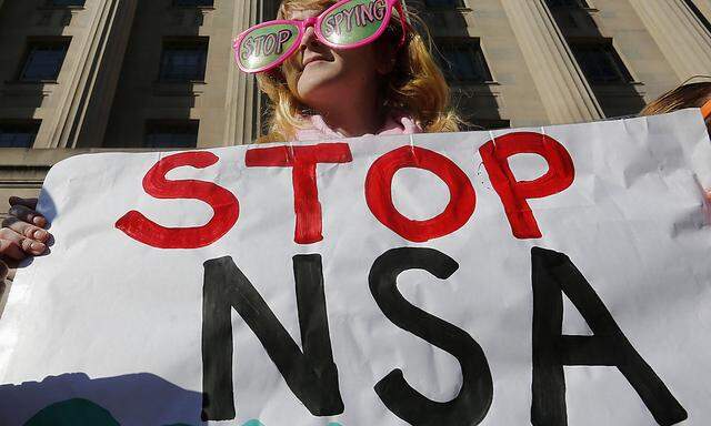 Member of protest group, Code Pink, Cayman Macdonald  protests against U.S. President Obama and NSA before his arrival at the Department of Justice in Washington