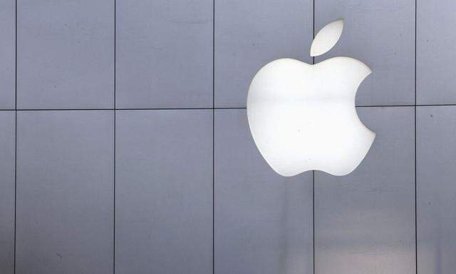 A policeman looks out from a balcony as the crowd is dispersed from the front of an Apple store in Beijing