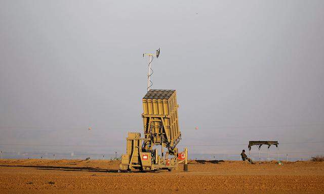 FILE PHOTO: An Israeli soldier keeps watch by an Iron Dome rocket interceptor battery deployed near central Gaza Strip
