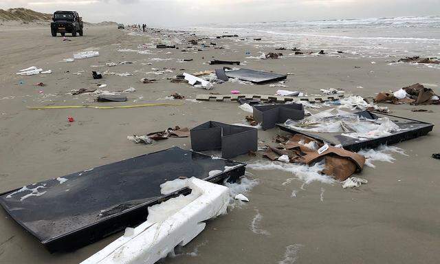 Flat-screen TVs and debris lie washed up on beach in Terschelling