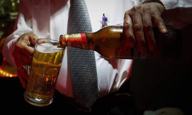 A bartender pours Haywards 5000 strong beer, a product of SABMiller, into a glass at a restaurant in Mumbai