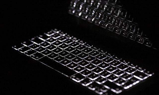 Backlit keyboard is reflected in screen of Apple Macbook Pro notebook computer
