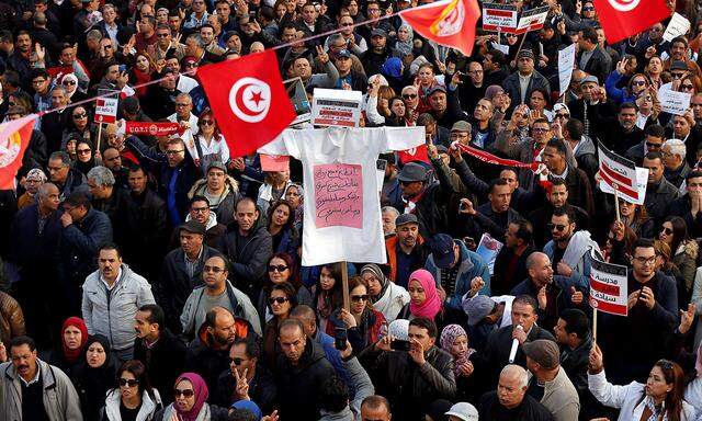 University professors and teachers take part in a protest to demand higher wages in Tunis