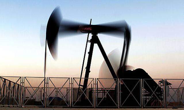 An oil pump works at sunset Tuesday, Feb. 21, 2012, in the desert oil fields of Sakhir, Bahrain.  Oil