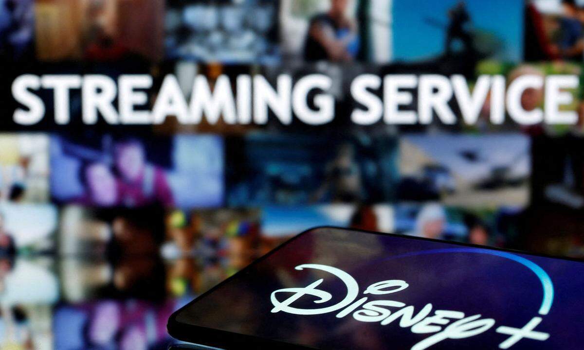FILE PHOTO: A smartphone screen showing the 'Disney+' logo is seen in front of the words 'streaming service' in this illustration